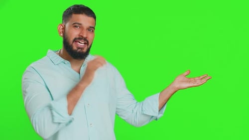 Young Man Showing Thumbs Up and Pointing at Right on Blank Space Place for your Advertisement Logo