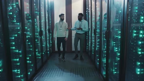 In a Server Room Two Men Discuss Technology and Teamwork