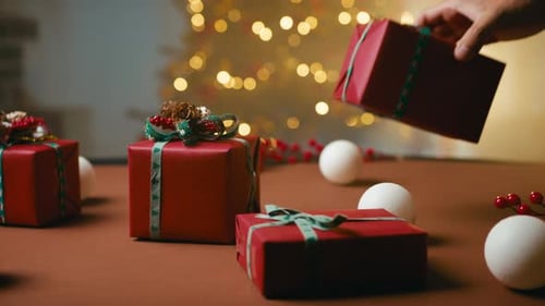 Christmas Presents with Christmas Tree Lights in Background