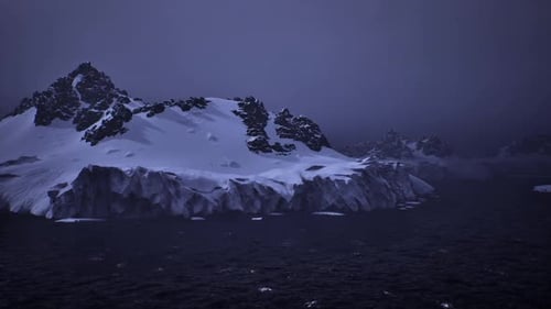 Distant Icy Landscape Under Moody Evening Sky Displaying Vastness