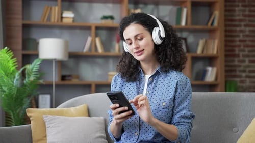 Woman Listening to Music on Phone Indoors