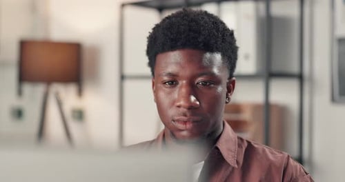 Business, black man and reading on laptop in office for research, editor feedback and proofreading