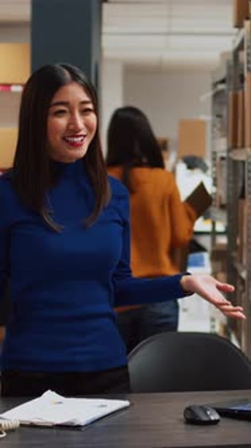 Woman Presents to Camera in a Warehouse