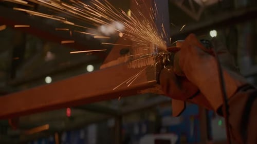 Craftsman Carefully Grinds Metal Angle with Angle Grinder
