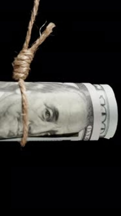 Vertical video. A Hundred-Dollar Bill Hanging On A Rope, Concept Of Dependence On Money, Limitation