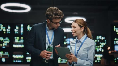Especialistas en tecnología de la información trabajando con tabletas por la noche, primer plano del centro de datos