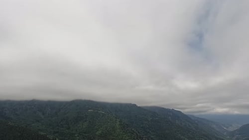 Green Tree Covered Mountains and Cloudy Covered Sky Time Lapse 4K
