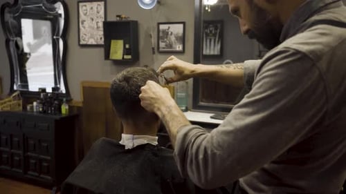 Barber Using Scissors And Comb - close up
