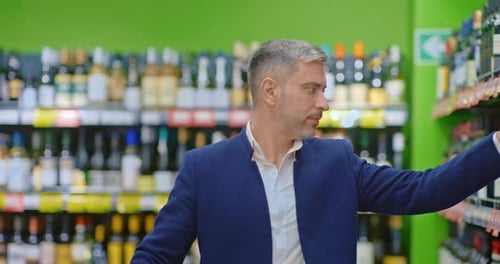 Handsome Adult Man Shopping in Liquor Store Choosing Red Wine Portrait in Supermarket Prores