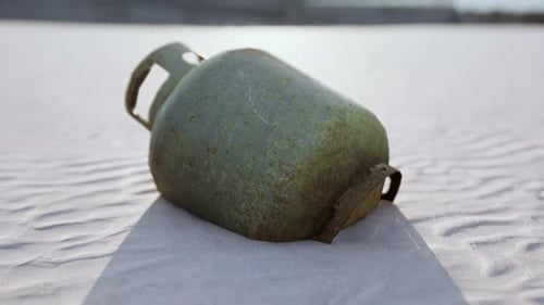 Old Rusted Metal Gas Tank on the Beach