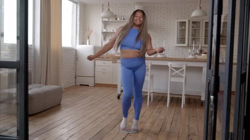 Woman Jumps Rope on Scale in Kitchen