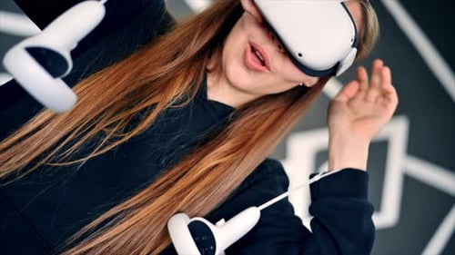 Woman Using Virtual Reality Headset and Controllers