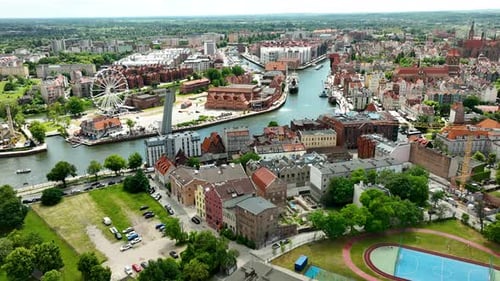 Aerial Gdańsk, showcasing the city's historic buildings, modern Ferris wheel, and the scenic Motława