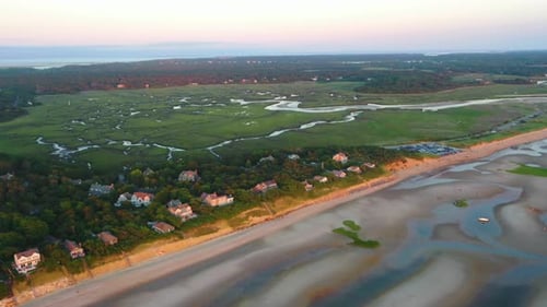 Cape Cod Bay Aerial Drone Footage of Beach Front Houses and Marsh at Low Tide During Golden Hour