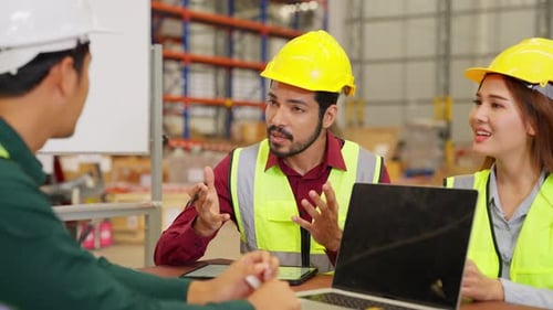 Happy Warehouse Engineers Team with Safety Vest Using Tablet