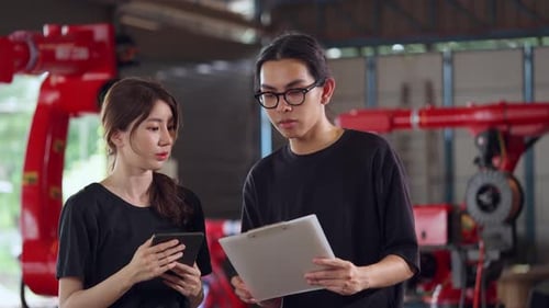 Engineers Work with Robotic Arm Technology