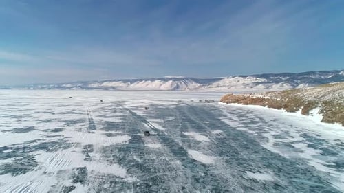Aerial View on Cars Driving on Cracked Ice of Baikal Near the Famous Tourist Spot Winter Landscape