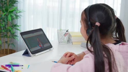 Girl Learning Remotely From Tablet in Bright Room