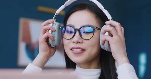 Woman with Headphones Using Computer at Work