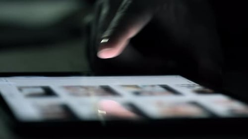 Finger Tapping on a Tablet Screen Close Up