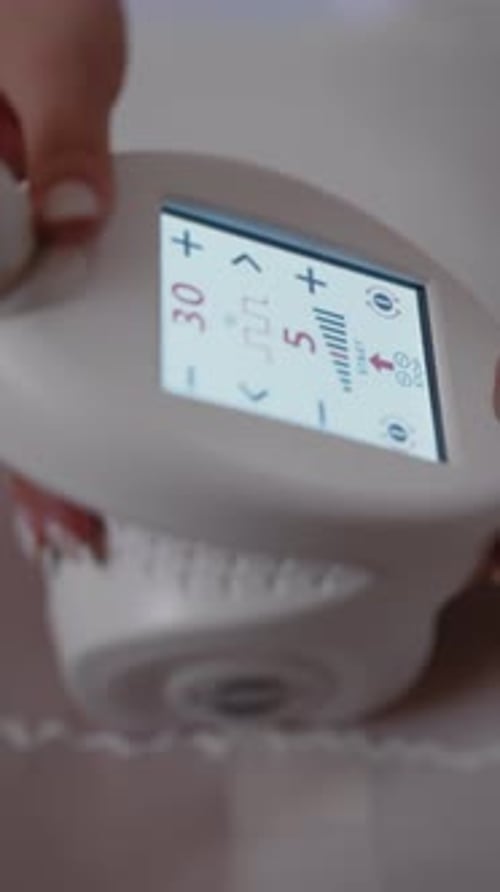Close Up IPL Device Display During Professional Hair Removal Treatment Session