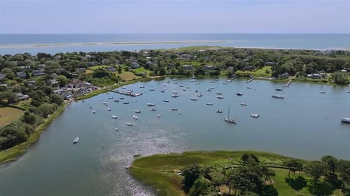 Aerial view of boats in a harbor with blue sky in Chatham, Cape Cod, USA.