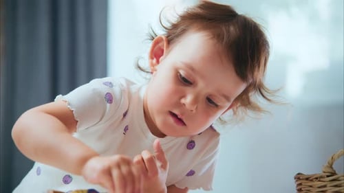 Adorable Toddler Playing with Clay Dough Indoors