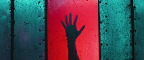 Silhouette of a Hand behind a Door