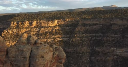 Aerial view of Colorado butte at sunset with side view drone video.