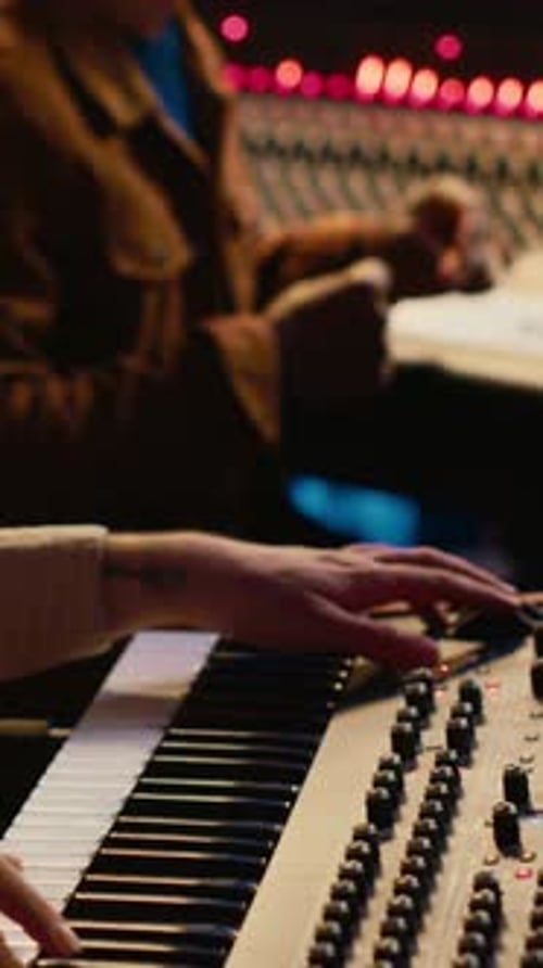 Vertical Video Musician Artist Playing Midi Controller Synthesizer in Recording Music Studio