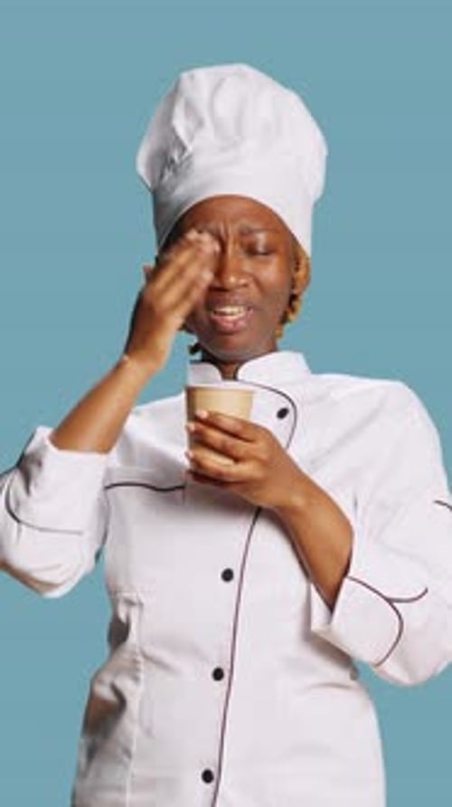 Vertical Video Exhausted Chef Yawning and Drinking Coffee on Camera