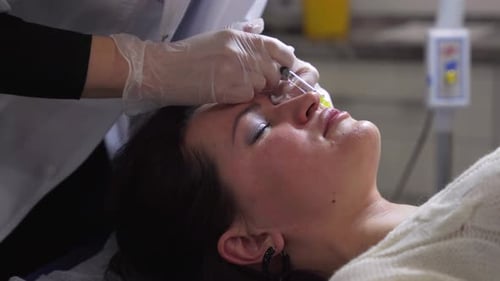 Woman Receiving Cosmetic Facial Injection in Hospital