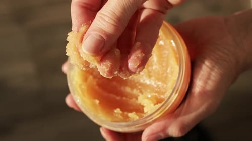 Hand Scooping Golden Sugar Scrub for Beauty
