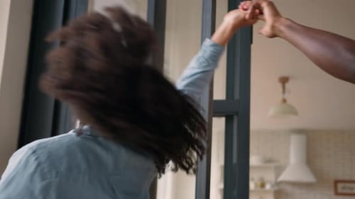 Happy Young Couple Dancing Together at Home