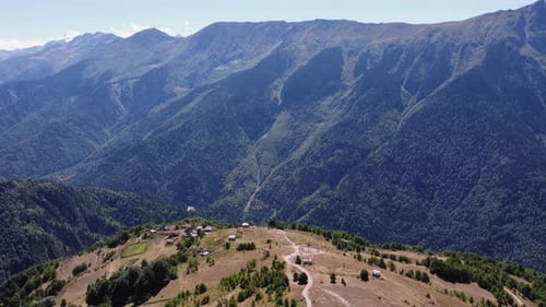 Aerial view of small village on ridge overlooking Caucasus mtn valley