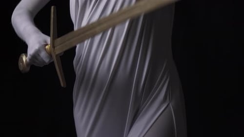 Themis is Lifting the Golden Sword to Bring Justice Close Up