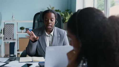 Young Operator Explaining Details of Service Providing to Online Client