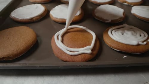 Close Up of Chef Decorating Cookies with Sweet Icing