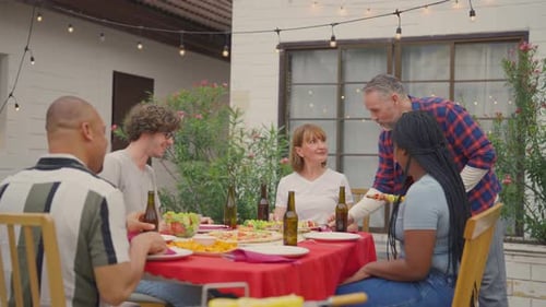 Multi-ethnic family having fun, enjoy party outdoors in the garden.