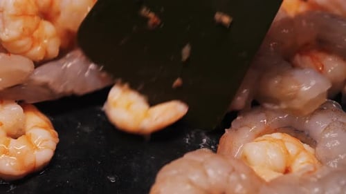 Closeup of Shrimp Being Cooked Over Low Heat in a Frying Pan