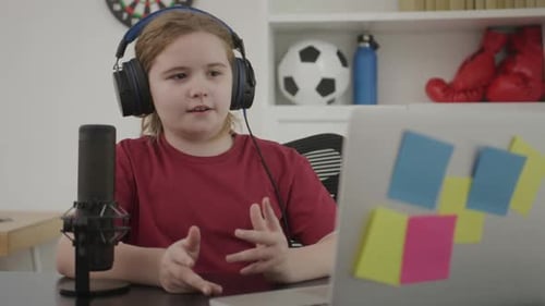 Enthusiastic Girl Vlogger Communicating Online with Microphone and Laptop