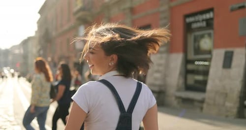 A Young Stylish Girl is Posing for the Camera on the Street
