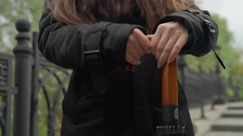 Closeup of Raincoat and Umbrella Intimate View of Woman Closing Umbrella in Rainy Weather Closeup