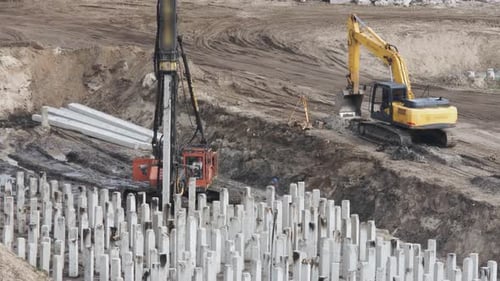 Piling Driving Machine at a Construction Site Drives a Pile Into the Ground Before Building the