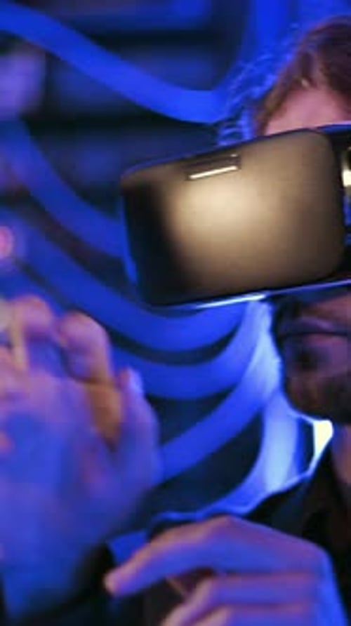 Man using a Virtual Reality headset in a server room. Vertical