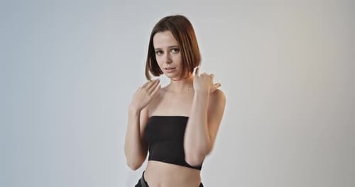 Young Woman Posing and Dancing in Studio