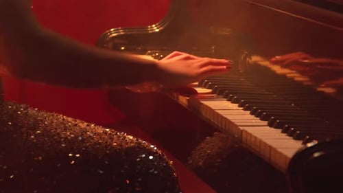 Woman Playing Piano in Glamorous Lighting