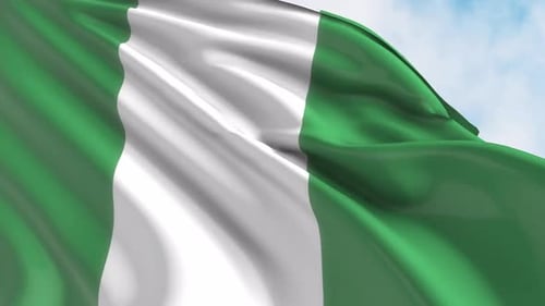 Realistic Waving Flag of Nigeria Against a Blue Sky