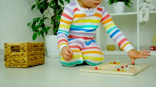 Cute Child Playing Puzzle at Home