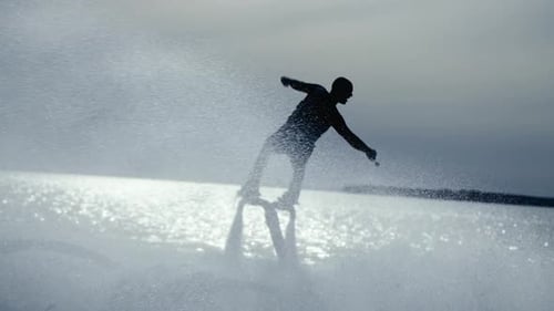 Flyboard Silhouette Performs Stunts on the Ocean